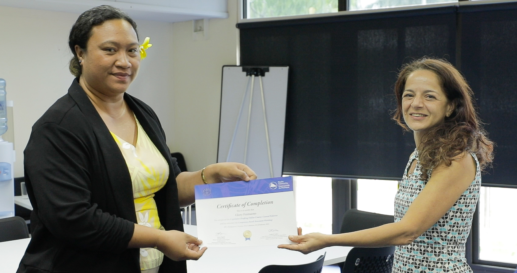 Glory receiving her final certificate from Ariella D'Andrea, SPC's Coastal Legal Adviser