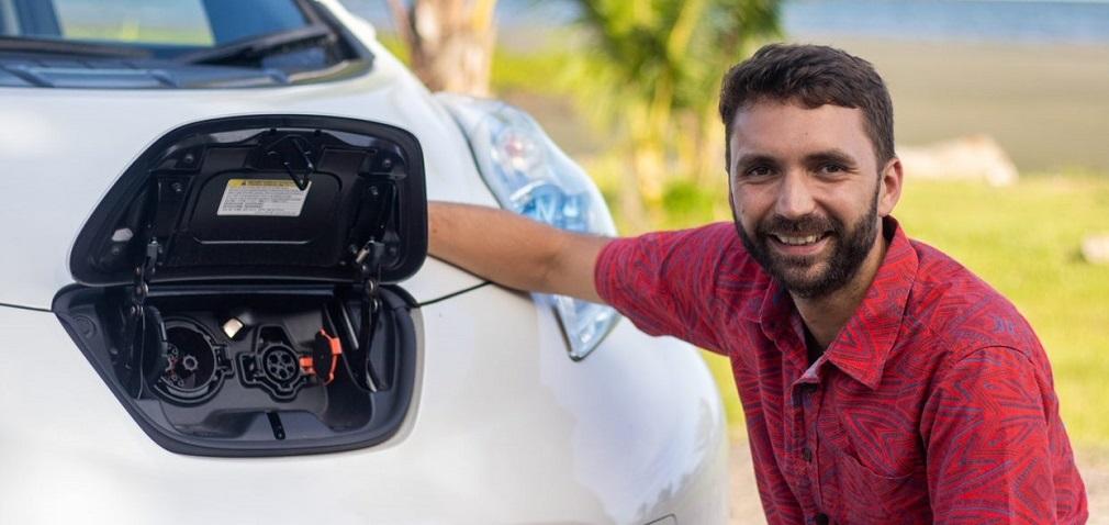 Alex Reddaway, owner and Director of Capital Leaf, with an electric Nissan Leaf in Suva.  