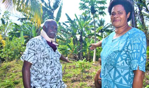 Remivani Baravi with her husband, showing her backyard plantation as a means to be self-reliant after disasters